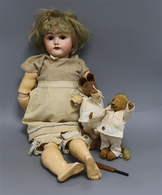 An early 20th century Bisque jointed doll with open mouth and sleeping eyes, and two small plush animals